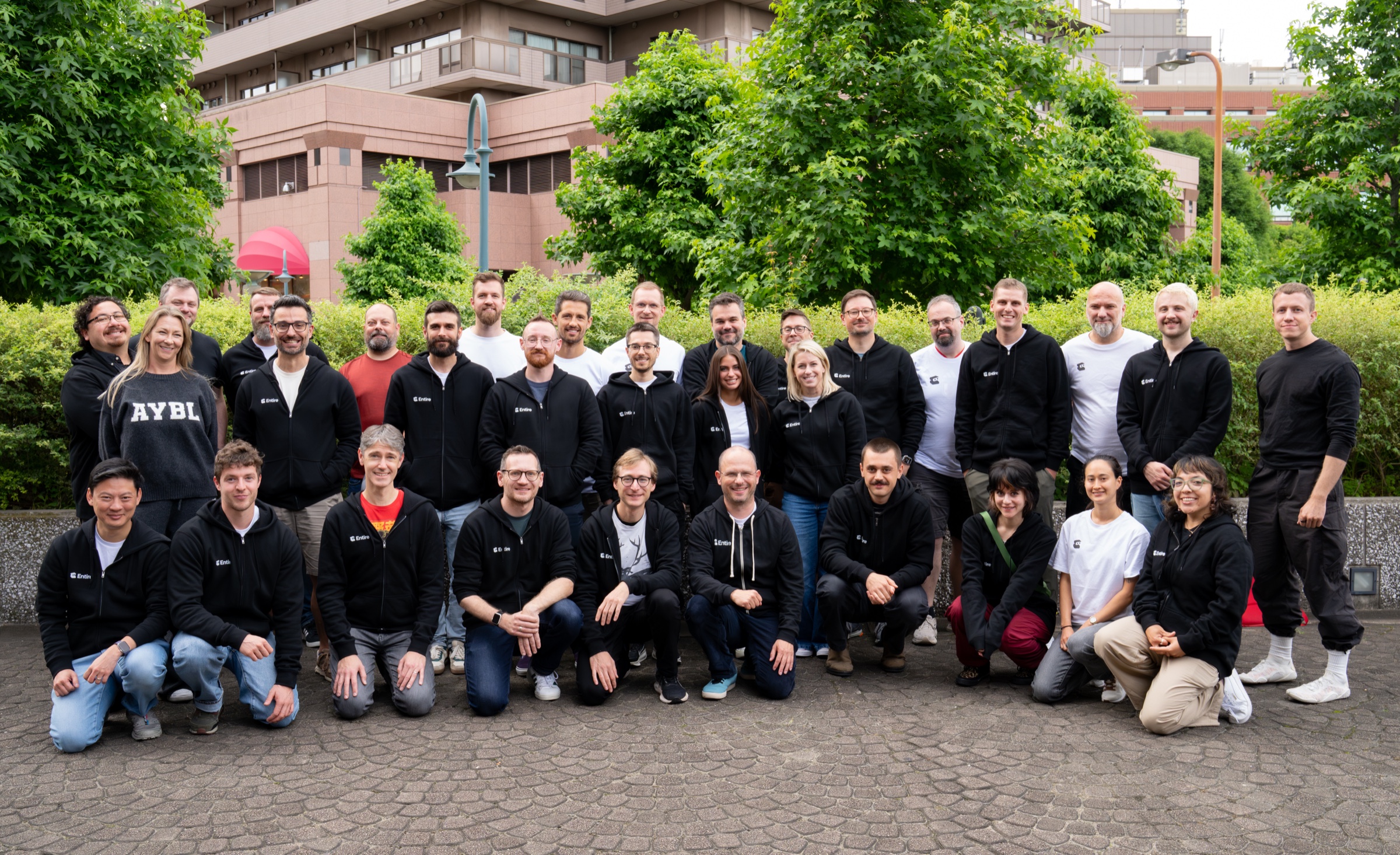 Entire team gathered outdoors during the Tokyo summit